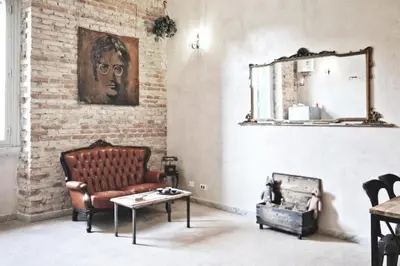 a living room with a couch and a mirror at Casa Particular Vintage in Rome