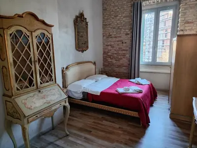 a bedroom with a bed and a dresser and a window at Casa Particular Vintage in Rome