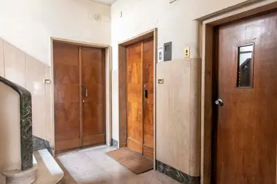 a hallway with two wooden doors in a house at Here's a new Laura's place - close to San Pietro in Rome
