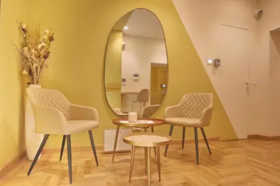 a dressing room with two chairs and a mirror at Dea Rome Suites in Rome