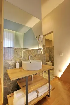 a bathroom with a sink and a mirror at Dea Rome Suites in Rome