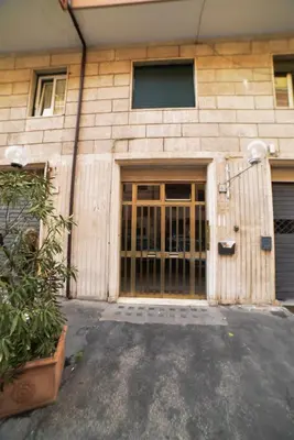 a building with a large door with a plant in front at Emily a Roma home in Rome