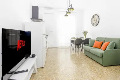 a living room with a green couch and a table at Emily a Roma home in Rome