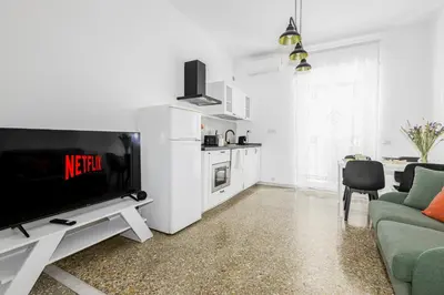 a living room with a tv and a kitchen at Emily a Roma home in Rome