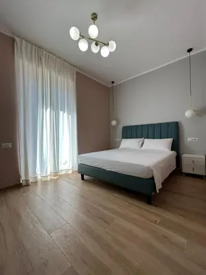 a bedroom with a bed and a green headboard at Roma Nostra Luxury B&B in Rome