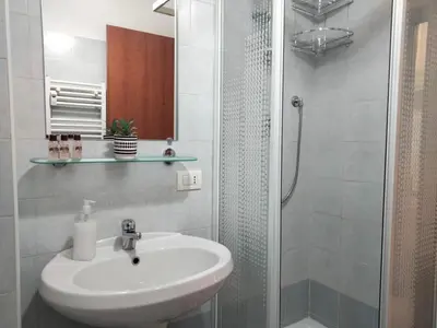 a white bathroom with a sink and a shower at RIPOLI APARTMENT in Rome