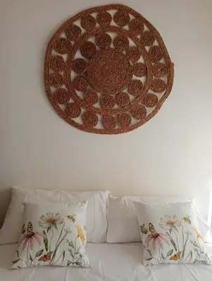 a plate on a wall above a bed with pillows at RIPOLI APARTMENT in Rome