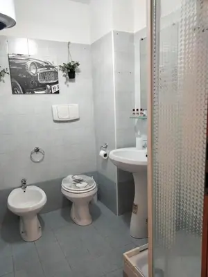 a bathroom with a sink and a toilet and a shower at RIPOLI APARTMENT in Rome