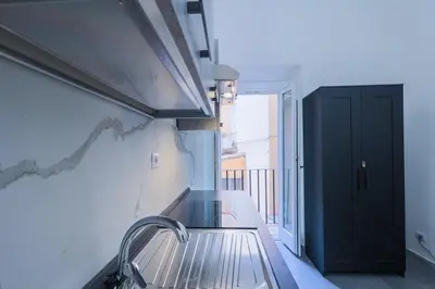 a kitchen with a sink and a black door at Casa Prefetti 46 B in Rome