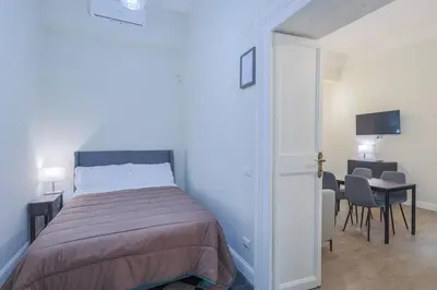 a bedroom with a bed and a table and chairs at Casa Prefetti 46 B in Rome
