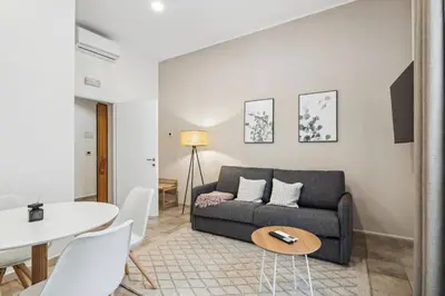 a living room with a couch and a table at Limehome Rome via dei Reti in Rome