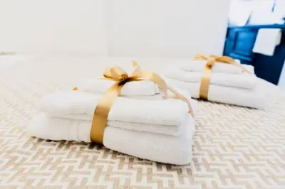 three folded towels with bows sitting on a bed at Pav Suite Rome in Rome
