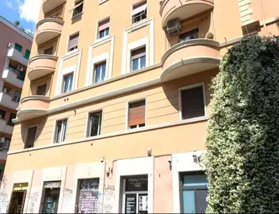 a building with a tree in front of it at Pav Suite Rome in Rome