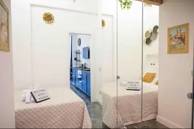 a bedroom with two beds and a mirror at Pav Suite Rome in Rome