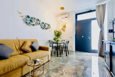 a living room with a couch and a table at Pav Suite Rome in Rome