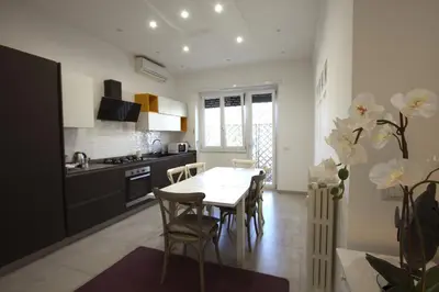 a kitchen with a table and chairs in a room at Piramide Holiday House in Rome