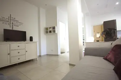 a living room with a couch and a tv at Piramide Holiday House in Rome
