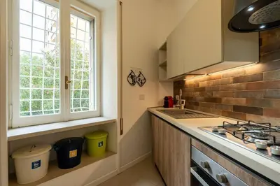 a kitchen with a sink and a stove and a window at Vaticano vicino metro A-Comfort ed eleganza in Rome
