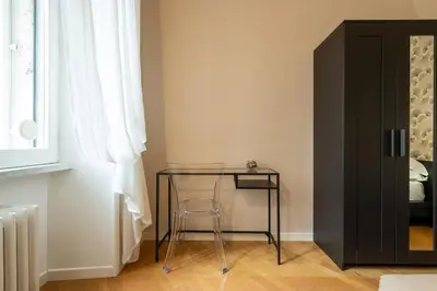 a glass table with a stool next to a window at Vaticano vicino metro A-Comfort ed eleganza in Rome