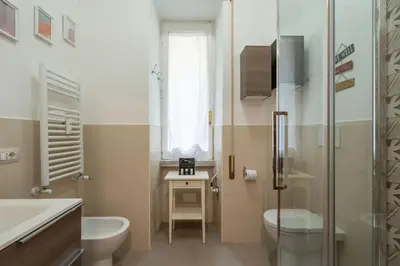 a bathroom with a toilet and a sink and a shower at Vaticano vicino metro A-Comfort ed eleganza in Rome