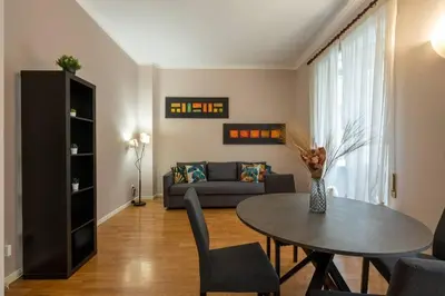 a living room with a table and a couch at Vaticano vicino metro A-Comfort ed eleganza in Rome