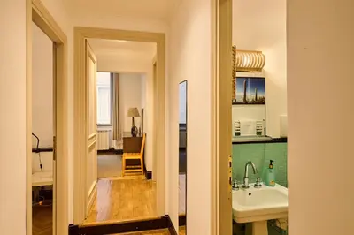 a hallway leading to a kitchen with a sink at Vittorio Apartment Rome in Rome