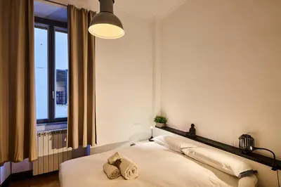 a bedroom with a bed with two towels on it at Vittorio Apartment Rome in Rome
