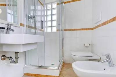 a bathroom with a shower and a sink and a toilet at LOFT CAPOCCI 37 - Home and More in Rome