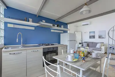 a kitchen with a table and a refrigerator at LOFT CAPOCCI 37 - Home and More in Rome
