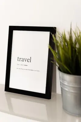 a picture frame sitting on a table next to a potted plant at central little basic apartment in Rome