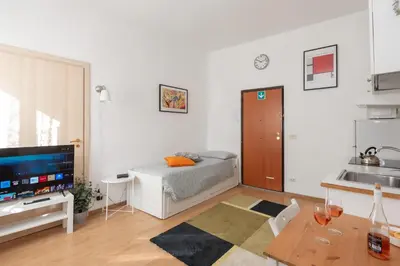 a living room with a bed and a table at central little basic apartment in Rome