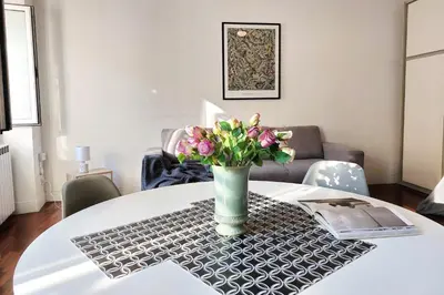 a vase of flowers sitting on a table at Cozy Navona Flat in Rome