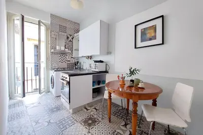 a kitchen with a wooden table and a table and chairs at Cozy Navona Flat in Rome