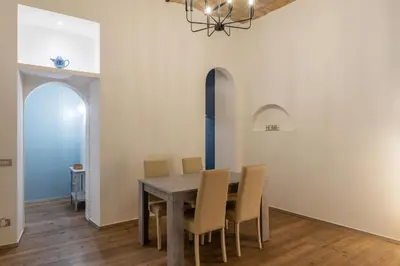 a dining room with a table and chairs at GuestHost - Nel cuore di Trastevere Cozy Apartment in Rome