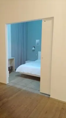 a bedroom with a white bed and blue walls at GuestHost - Nel cuore di Trastevere Cozy Apartment in Rome