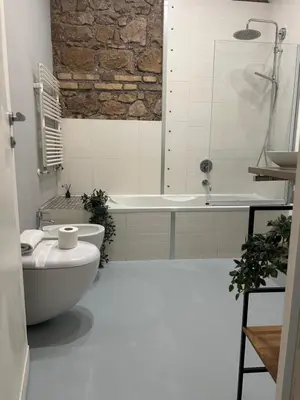 a bathroom with a tub and a toilet and a sink at GuestHost - Nel cuore di Trastevere Cozy Apartment in Rome