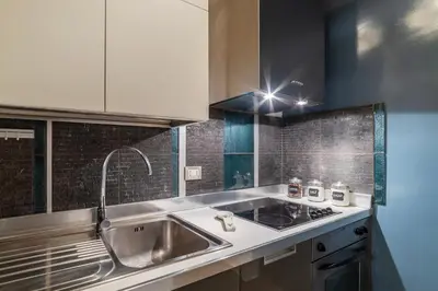 a kitchen with a sink and a counter top at GuestHost - Nel cuore di Trastevere Cozy Apartment in Rome
