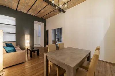 a dining room and living room with a table and chairs at GuestHost - Nel cuore di Trastevere Cozy Apartment in Rome
