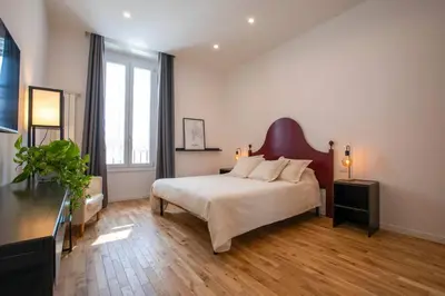 a bedroom with a bed and a large window at Effe 9 Apartment - p.le Flaminio in Rome
