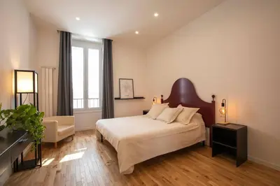 a bedroom with a large bed and a chair at Effe 9 Apartment - p.le Flaminio in Rome
