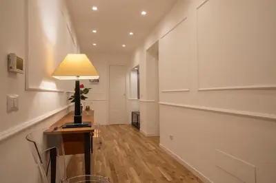 a hallway with a table with a lamp on it at Effe 9 Apartment - p.le Flaminio in Rome