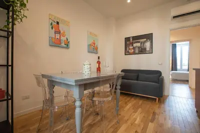 a living room with a table and a couch at Effe 9 Apartment - p.le Flaminio in Rome