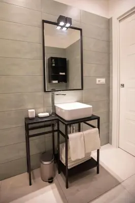a bathroom with a sink and a mirror at Effe 9 Apartment - p.le Flaminio in Rome