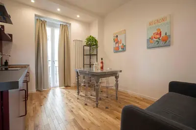 a living room with a table in the middle of a kitchen at Effe 9 Apartment - p.le Flaminio in Rome