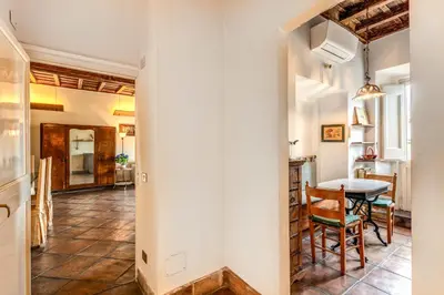 a kitchen and dining room with a table and chairs at Flat with Lovely Views near Piazza Navona in Rome