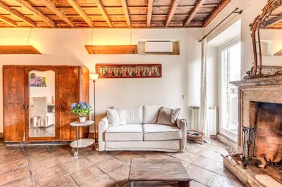 a living room with a couch and a fireplace at Flat with Lovely Views near Piazza Navona in Rome