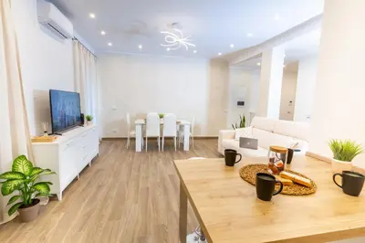a large living room with a couch and a tv at Noh Collection 2BDR apartment- Vatican Area in Rome
