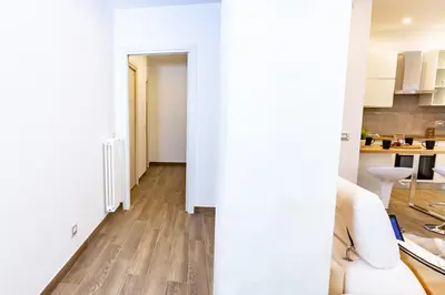 a living room with white walls and wooden floors at Noh Collection 2BDR apartment- Vatican Area in Rome