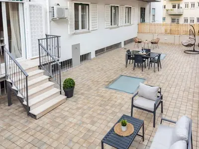 a patio with a table and chairs and a staircase at Noh Collection 2BDR apartment- Vatican Area in Rome