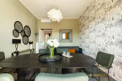 a dining room with a table and chairs at Cozy apartment Gianicolense 3bdr in Rome